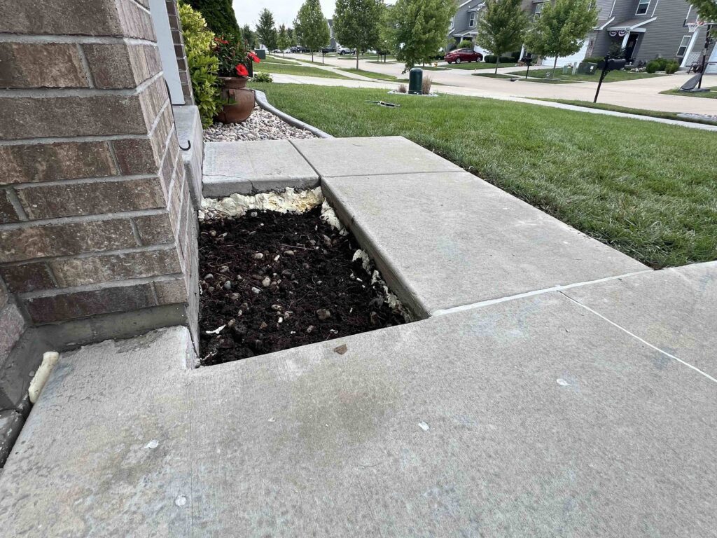 Sidewalk lifted and void filled for added support